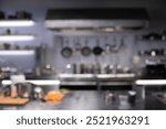 Interior of restaurant kitchen with professional utensils, out of focus, blurred