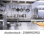 Interior of restaurant kitchen with professional utensils, out of focus