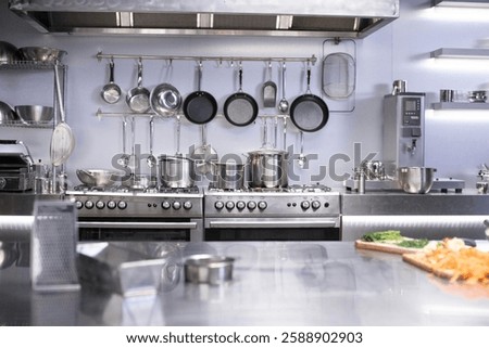 Interior of restaurant kitchen with professional utensils, out of focus