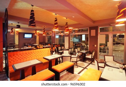 Interior of a restaurant, modern design in few colors, orange and ... Interior of a restaurant, modern design in few colors, orange and ...