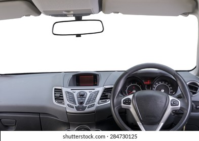 Interior Of Right Hand Drive Car. Image Shows Driver Controls, Dashboard, Central Rear View Mirror And Sun Visors. Windscreen (windshield) Is Isolated White, So As Rear View Mirror. 