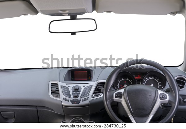 Interior of\
right hand drive car. Image shows driver controls, dashboard,\
central rear view mirror and sun visors. Windscreen (windshield) is\
isolated white, so as rear view mirror.\
