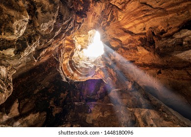 Interior of a rocky cave illuminated by sunlight - Shutterstock ID 1448180096
