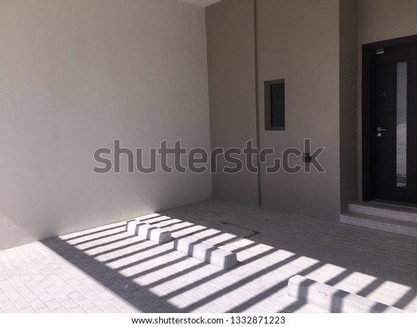 Interior of Roofed Car Parking in a villa with\
shadow of roof.