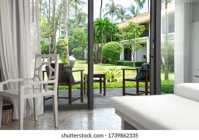 Interior Of The Room With A Beautiful Wooden Chair And Access To The Terrace And Garden.