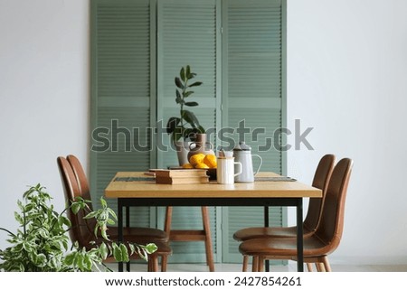 Interior of room with dining table and folding screen