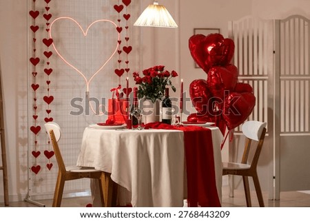 Interior of room with dining table served for Valentine's Day