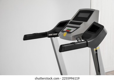 Interior of room with modern treadmill near grey wall, closeup - Shutterstock ID 2255996119
