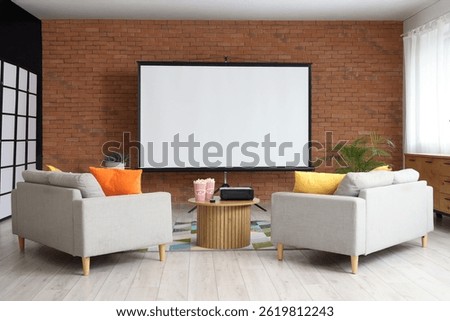 Interior of room with sofas, table and projector screen