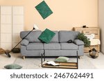 Interior of ruined living room with sofa after earthquake