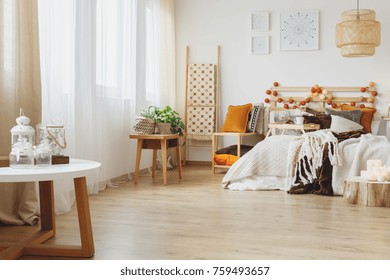 Interior of a scandinavian design bedroom with a small stylish table