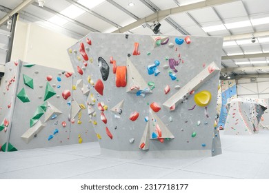 Interior shot of indoor climbing centre without people with assortment of colorful and challenging climbing walls - Powered by Shutterstock