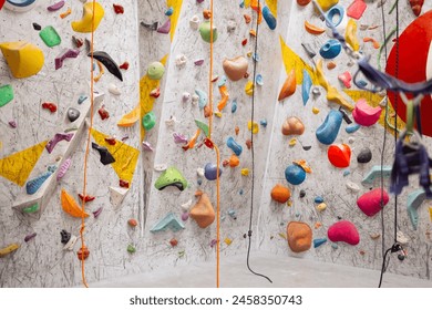 Interior shot of indoor climbing centre without people with assortment of colorful and challenging climbing walls. White wall with climbing holds in gym. Indoor sport bouldering extreme sport concept. - Powered by Shutterstock