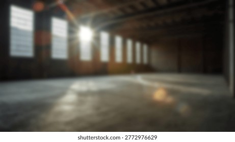 An interior shot of a large, empty warehouse with sunlight streaming through multiple windows, creating a bright and airy atmosphere. The concrete floor reflects the light.