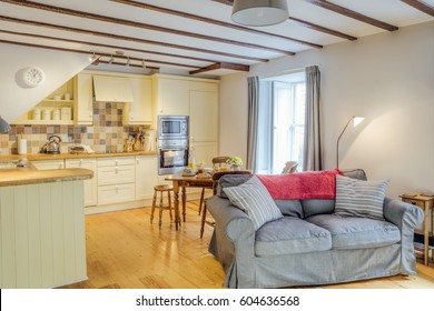 Interior Shot Of A Log Cabin Living Room And Kitchen.