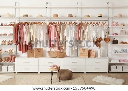 Interior of show room with stylish clothes and accessories