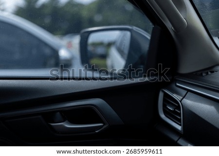 Interior side mirror view of the car,View from the car interior with side mirror reflecting trees.