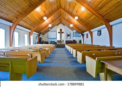 The interior of a simple church with a vaulted wooden ceiling and beams - Shutterstock ID 178899881