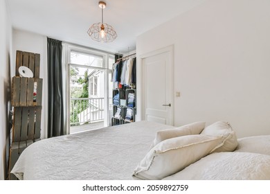 The Interior Of A Small Cozy Bedroom With A Double Bed