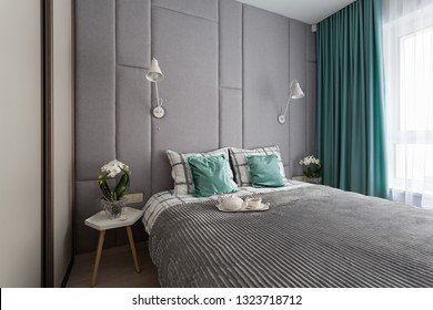 Interior Of A Small Cozy Bedroom With Grey Padded Wall