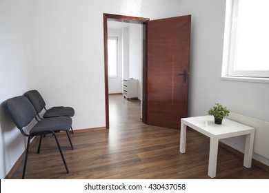 Interior Of Small Empty Doctor's Consulting Room And Waiting Room Without People.