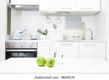 Interior Of Small White Kitchen With Fresh Apples On The Table