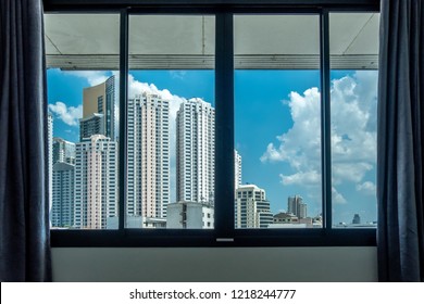 Interior space of modern empty office with city background. Window view of Manhattan city in Bangkok. Urban Scene Skyline Morning View Metropolis Concept. detailed view through floor to ceiling tower.