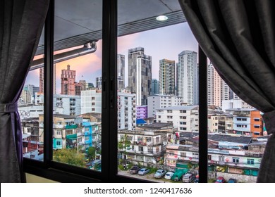 Interior space of modern empty office with city background. Window view of Manhattan city in Bangkok. Urban Scene Skyline night view metropolis concept. Detailed of the window view building hostel.