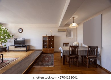 Interior of a spacious apartment with a dining table and chairs