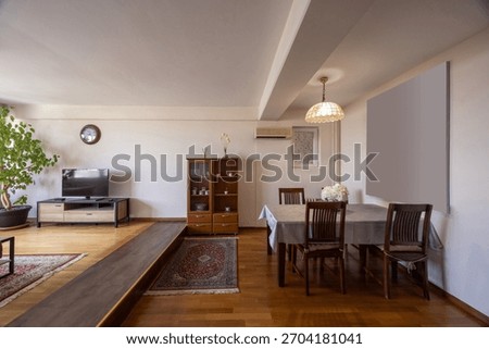 Interior of a spacious apartment with a dining table and chairs