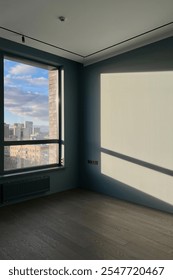 Interior of spacious empty old room with laminated floor with windows. Empty room in new apartment after renovation.
