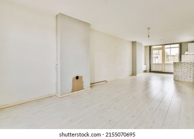 Interior Of Spacious Light Room With Fireplace And Elegant Chandelier Against Windows