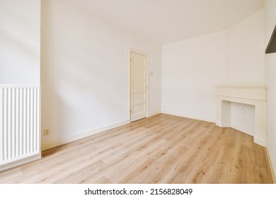 Interior Of Spacious Light Room With Fireplace And Elegant Chandelier