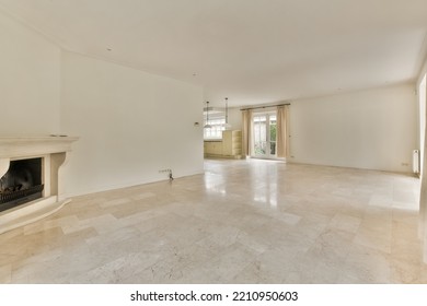 Interior Of Spacious Light Room With Fireplace Against Door And Windows