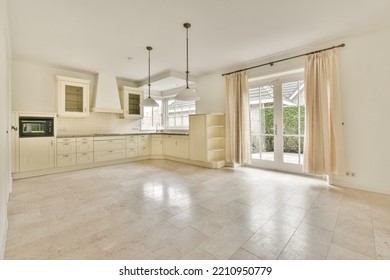 Interior Of Spacious Light Room With Fireplace Against Door And Windows