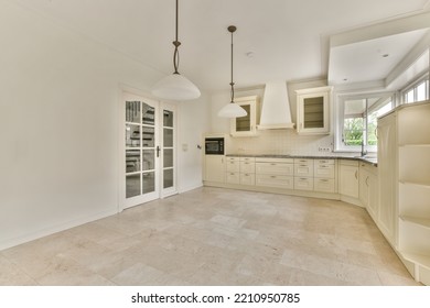 Interior Of Spacious Light Room With Fireplace Against Door And Windows