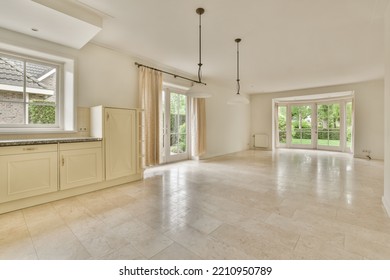 Interior Of Spacious Light Room With Fireplace Against Door And Windows