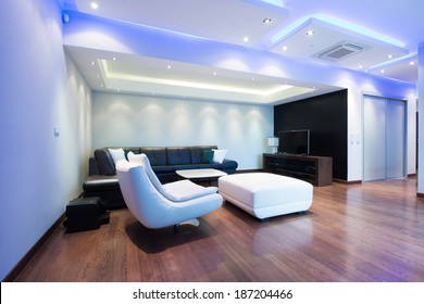 Interior of a spacious luxury living room with colorful ceiling lights