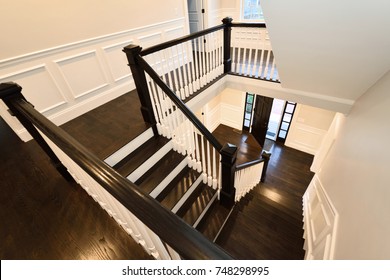 Interior Staircase In New Home. Colonial Style, Dark Hardwood Floor.