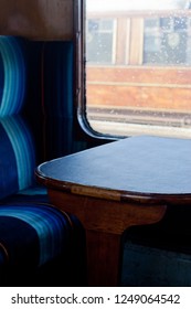 Interior Of A Steam Train Showing Seat And Wooden Table