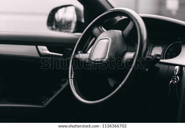 interior, the steering wheel of a luxury car. black\
leather trim.