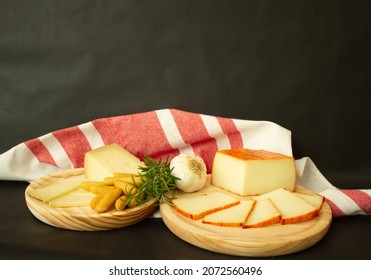 Interior Still Life With Cheese Boards, Tea Towel And Black Background
