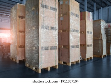Interior of storage warehouse with stack wooden crates wrapped plastic. L-shape pallet corrugated paper cardboard Angle corner edge protector. shipping warehouse. cargo export  import. - Shutterstock ID 1911887104