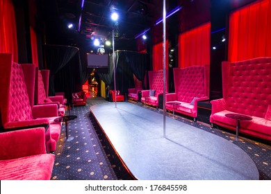 Interior Strip Club With Sofas And Tables Poles