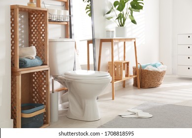 Interior of stylish bathroom with toilet bowl and decor elements