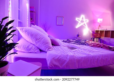 Interior Of Stylish Bedroom With Neon Lighting