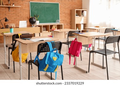 Interior of stylish empty classroom with backpacks and stationery - Shutterstock ID 2337019229