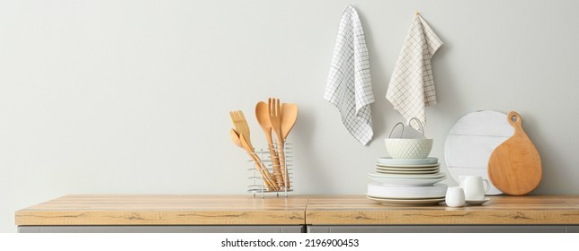 Interior of stylish kitchen with utensils and dinnerware on counter - Powered by Shutterstock