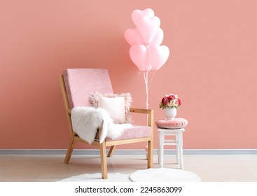 Interior of stylish living room with armchair and pink balloons for Valentine's Day