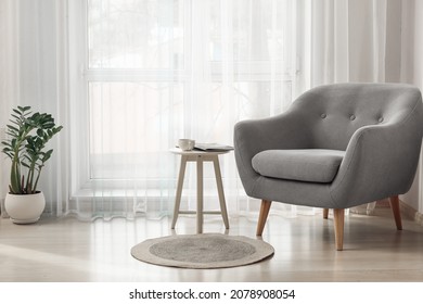 Interior of stylish living room with comfortable armchair - Shutterstock ID 2078908054